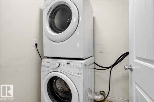 Laundry area featuring stacked washer / drying machine - 12761 119 St, Edmonton, AB - Indoor Photo Showing Laundry Room