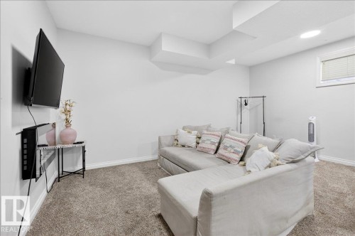 Living area featuring light carpet and baseboards - 12761 119 St, Edmonton, AB - Indoor