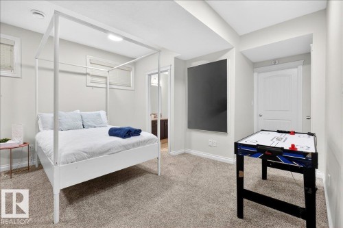 Carpeted bedroom with baseboards and ensuite bath - 12761 119 St, Edmonton, AB - Indoor Photo Showing Bedroom