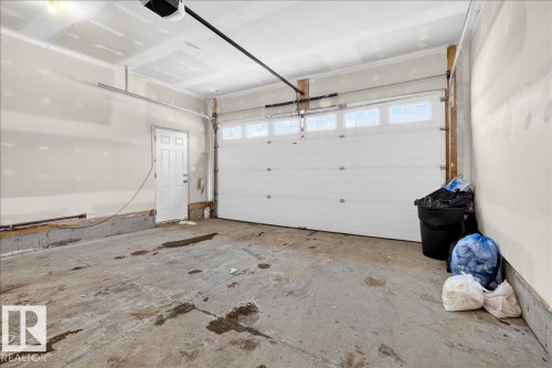 Garage featuring a garage door opener - 12761 119 St, Edmonton, AB - Indoor Photo Showing Garage