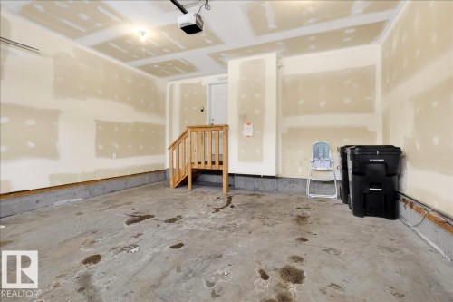Garage featuring a garage door opener - 12761 119 St, Edmonton, AB - Indoor