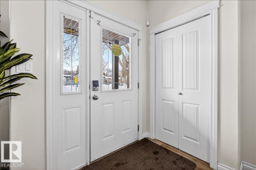 Foyer entrance featuring wood finished floors - 12761 119 St, Edmonton, AB - Indoor Photo Showing Other Room