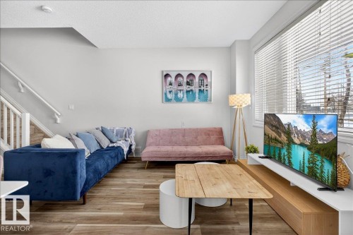Living area with wood finished floors and a textured ceiling - 12761 119 St, Edmonton, AB - Indoor Photo Showing Living Room