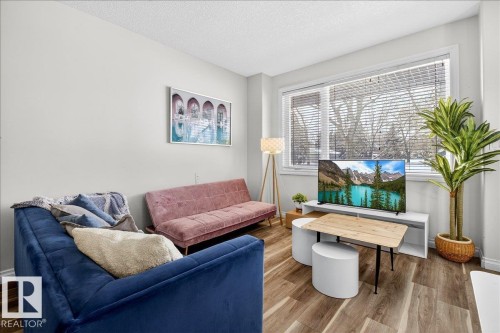 Sitting room featuring wood finished floors and a textured ceiling - 12761 119 St, Edmonton, AB - Indoor Photo Showing Living Room