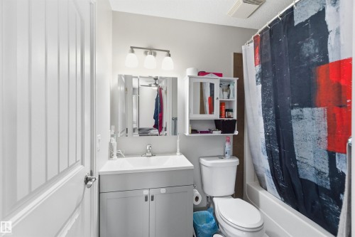 Full bath with vanity, shower / tub combo with curtain, and a ceiling fan - 3908 161 Avenue Nw, Edmonton, AB - Indoor Photo Showing Bathroom