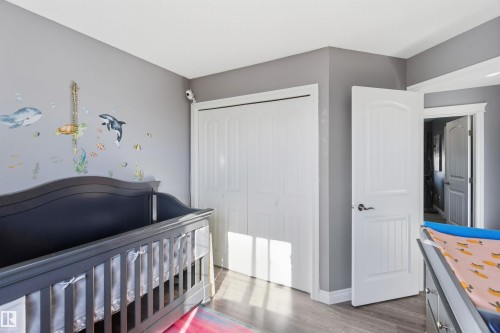 Bedroom with a nursery area, a closet, and wood finished floors - 3908 161 Avenue Nw, Edmonton, AB - Indoor Photo Showing Bedroom