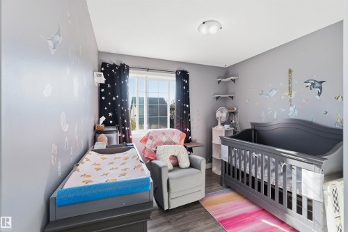 Bedroom featuring a nursery area and wood finished floors - 3908 161 Avenue Nw, Edmonton, AB - Indoor Photo Showing Bedroom