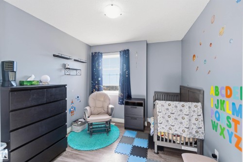 Bedroom with wood finished floors and a nursery area - 3908 161 Avenue Nw, Edmonton, AB - Indoor Photo Showing Bedroom