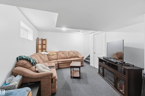 Living area featuring carpet flooring and stairs - 3908 161 Avenue Nw, Edmonton, AB - Indoor Photo Showing Other Room