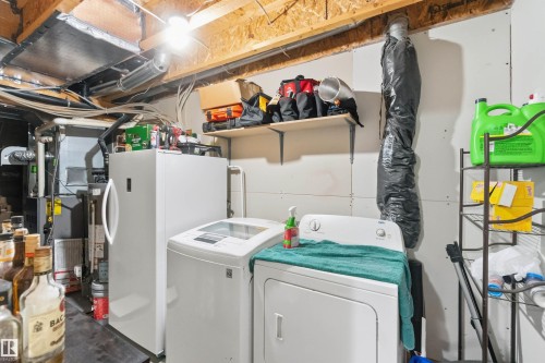 Laundry area with separate washer and dryer, concrete flooring, and gas water heater - 3908 161 Avenue Nw, Edmonton, AB - Indoor Photo Showing Laundry Room
