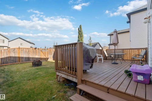 Wooden deck with a fire pit and a fenced backyard - 3908 161 Avenue Nw, Edmonton, AB - Outdoor With Deck Patio Veranda With Exterior
