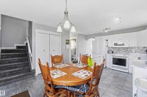 Dining area featuring stairs and arched walkways - 3908 161 Avenue Nw, Edmonton, AB - Indoor Photo Showing Dining Room