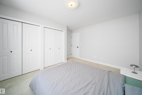 Bedroom featuring light colored carpet and multiple closets - 15 Chambery Crescent, St. Albert, AB - Indoor Photo Showing Bedroom