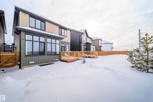 Snow covered house with a fenced backyard and a deck - 15 Chambery Crescent, St. Albert, AB - Outdoor With Exterior