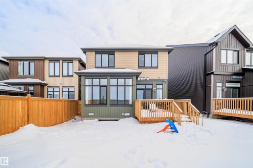 Snow covered property with a sunroom, a deck, and crawl space - 15 Chambery Crescent, St. Albert, AB - Outdoor