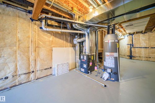 Unfinished basement featuring gas water heater and heating unit - 15 Chambery Crescent, St. Albert, AB - Indoor Photo Showing Basement