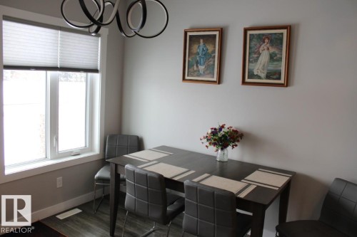 Dining space featuring dark wood-type flooring and baseboards - 22 6519 46 Street, Wetaskiwin, AB - Indoor Photo Showing Dining Room