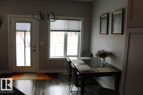 Dining space with dark wood-type flooring and hanging lights - 22 6519 46 Street, Wetaskiwin, AB - Indoor Photo Showing Dining Room