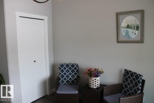 Sitting room with wood finished floors - 22 6519 46 Street, Wetaskiwin, AB - Indoor