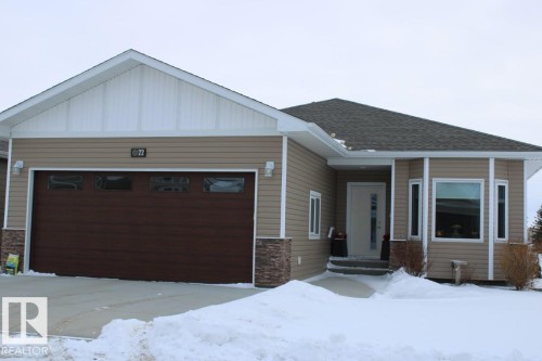 View of front facade featuring an attached garage, a shingled roof, board and batten siding, and stone siding - 22 6519 46 Street, Wetaskiwin, AB - Outdoor With Facade