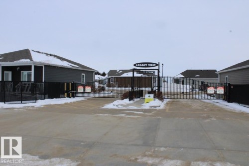 Yard covered in snow featuring a gate - 22 6519 46 Street, Wetaskiwin, AB - Outdoor