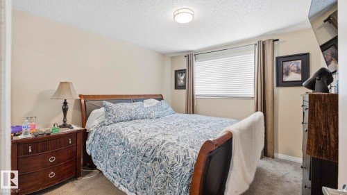 Bedroom with carpet flooring and a textured ceiling - 4502 50A Avenue, Beaumont, AB - Indoor Photo Showing Bedroom