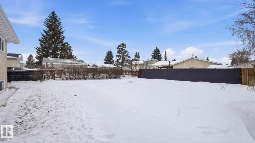 Yard layered in snow featuring a fenced backyard - 4502 50A Avenue, Beaumont, AB - Outdoor