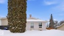 Snow covered property featuring a chimney - 4502 50A Avenue, Beaumont, AB  - Outdoor 