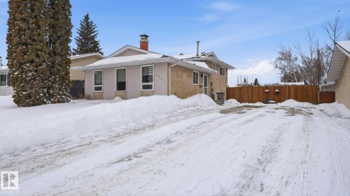 View of snow covered exterior featuring a chimney - 4502 50A Avenue, Beaumont, AB - Outdoor