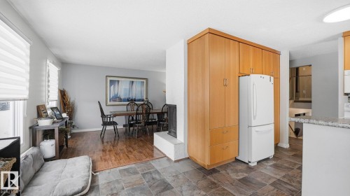 Kitchen featuring freestanding refrigerator and stone finish floors - 4502 50A Avenue, Beaumont, AB - Indoor