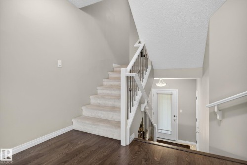Entryway featuring dark wood finished floors, a textured ceiling, and stairs - 1717 Chapman Way, Edmonton, AB - Indoor Photo Showing Other Room