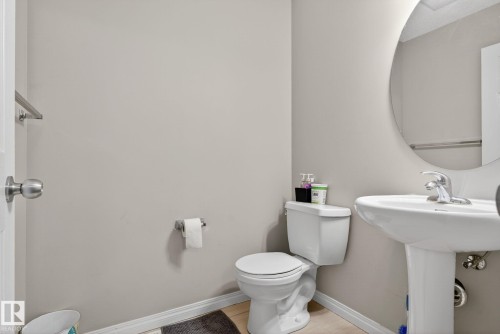 Half bathroom featuring toilet and light wood-style floors - 1717 Chapman Way, Edmonton, AB - Indoor Photo Showing Bathroom