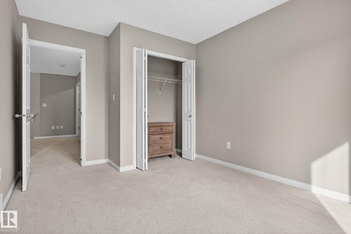 Unfurnished bedroom with light colored carpet and a closet - 1717 Chapman Way, Edmonton, AB - Indoor Photo Showing Other Room