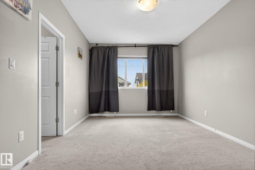 Spare room with light colored carpet and a textured ceiling - 1717 Chapman Way, Edmonton, AB - Indoor