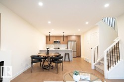 Dining area with light wood finished floors, recessed lighting, and a fireplace - 