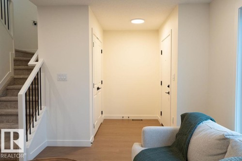 Hallway with baseboards and light wood finished floors - 11738 91 Street Nw, Edmonton, AB - Indoor Photo Showing Other Room