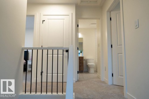 Hall with light carpet and baseboards - 11738 91 Street Nw, Edmonton, AB - Indoor Photo Showing Other Room