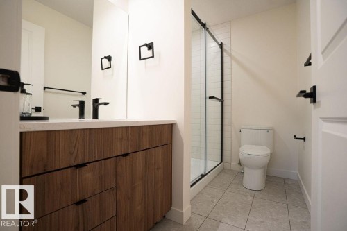 Full bath featuring vanity, light tile patterned floors, and a stall shower - 11738 91 Street Nw, Edmonton, AB - Indoor Photo Showing Bathroom