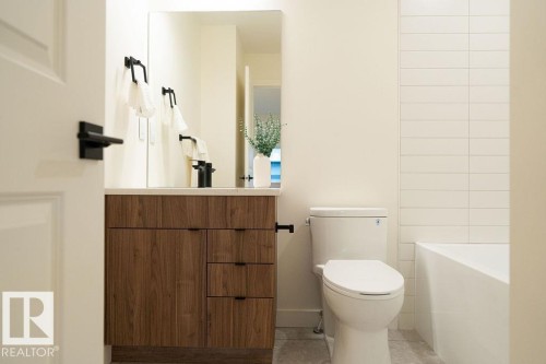 Bathroom with vanity, light tile patterned floors, and a bathtub - 11738 91 Street Nw, Edmonton, AB - Indoor Photo Showing Bathroom