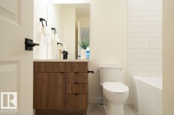 Bathroom with vanity, light tile patterned floors, and a bathtub - 