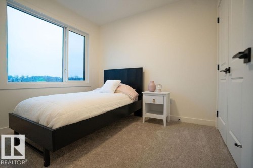 Carpeted bedroom featuring baseboards - 11738 91 Street Nw, Edmonton, AB - Indoor Photo Showing Bedroom