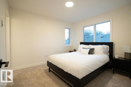 Bedroom with light carpet and baseboards - 11738 91 Street Nw, Edmonton, AB - Indoor Photo Showing Bedroom