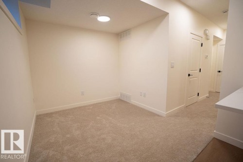 Spare room with light carpet and baseboards - 11738 91 Street Nw, Edmonton, AB - Indoor Photo Showing Other Room