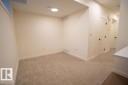 Spare room with light carpet and baseboards - 