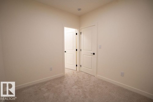 Carpeted empty room featuring baseboards - 11738 91 Street Nw, Edmonton, AB - Indoor Photo Showing Other Room