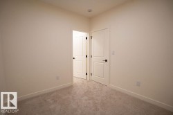 Carpeted empty room featuring baseboards - 