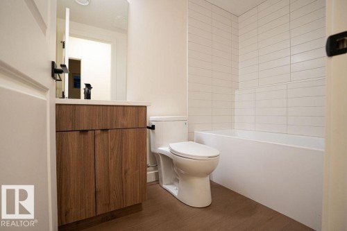 Full bath with vanity, dark wood-style flooring, and shower / bathtub combination - 11738 91 Street Nw, Edmonton, AB - Indoor Photo Showing Bathroom