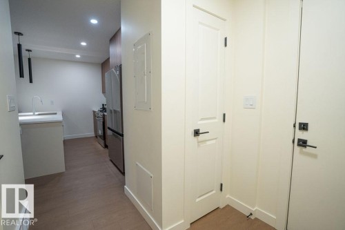 Hall featuring dark wood-type flooring, recessed lighting, and electric panel - 11738 91 Street Nw, Edmonton, AB - Indoor Photo Showing Other Room