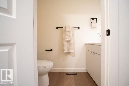 Bathroom featuring vanity and dark wood-style flooring - 11738 91 Street Nw, Edmonton, AB - Indoor Photo Showing Bathroom