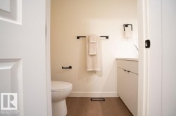 Bathroom featuring vanity and dark wood-style flooring - 